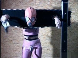 Gimp girl locked in box and pillory